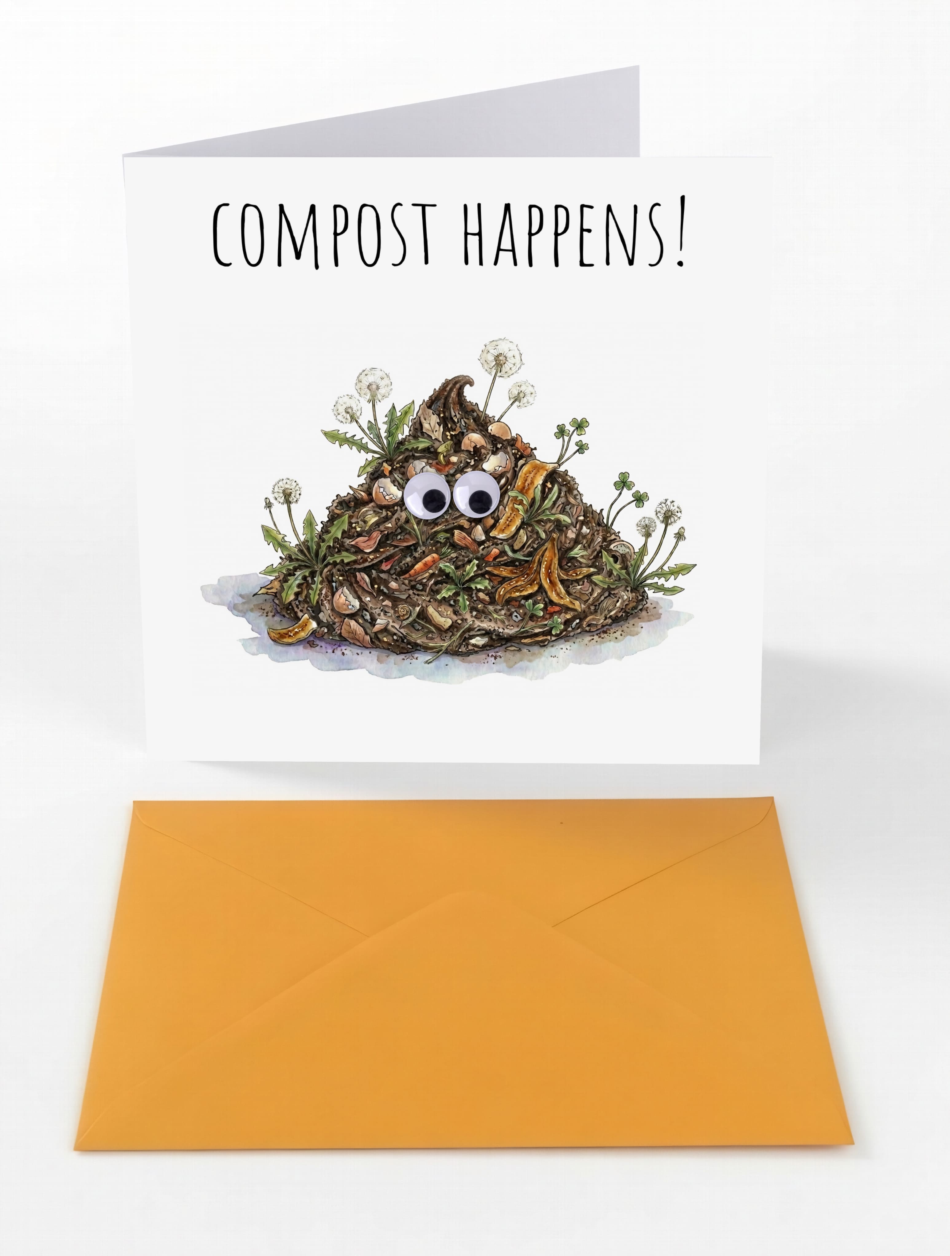 Funny "Compost Happens!" greeting card with googly eyes and orange envelope from M N House Wholesale, featuring humorous compost-themed design.