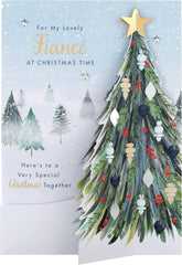 Hallmark boxed Christmas greeting card for fiancé featuring a classic winter scene with a decorated tree design.