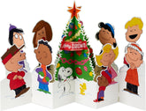 Hallmark Christmas greeting card featuring 3D pop-up Peanuts characters Charlie Brown, Snoopy, and a Christmas tree.