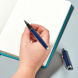 Helix Oxford Premium Rollerball Pen with blue ink, shown in plastic-free packaging, featuring a sleek pen design.