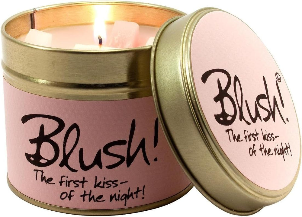 Lily-Flame Blush scented tin candle with pink floral design and a lit wick, showcasing a cozy, fragrant candle in a metal tin.