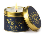 Lily-Flame Christmas Eve scented tin candle with festive holiday design and warm candle wick visible.
