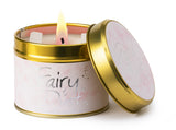 Lily-Flame Fairy Dust scented tin candle with decorative label and closed lid, ideal for adding a magical touch to your space