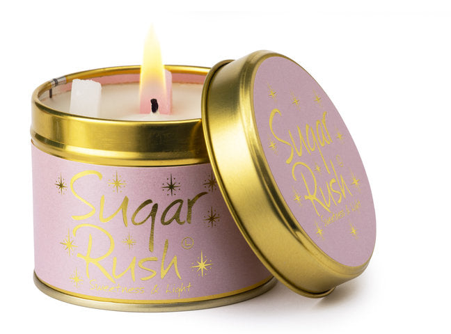 Lily-Flame Sugar Rush scented tin candle with colorful packaging and a lit wick, perfect for home fragrance.