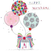 Second Nature birthday card featuring a hand holding decorated balloons with finished button embellishments, designed for celebrations.
