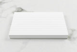 Silvine 5 x 3-inch 100% recycled lined record cards, white, set of 100, showing neatly stacked flash cards for study or organization.
