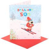 UK Greetings Boofle skiing son Christmas card featuring Boofle character in winter attire on festive holiday background