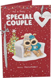 UK Greetings Boofles sitting on couch Christmas card featuring a cute cartoon couple, perfect for holiday greetings.