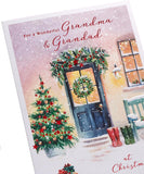 UK Greetings Christmas greeting card for Grandma and Grandad featuring a snowy door design, perfect for holiday wishes.