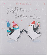 UK Greetings Christmas greeting card featuring adorable penguins ice skating, designed for sister and brother-in-law.