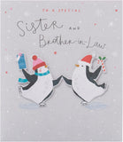 UK Greetings Christmas greeting card featuring adorable penguins ice skating, designed for sister and brother-in-law.