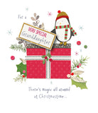 UK Greetings Christmas greeting card featuring a cute penguin holding a present for a special granddaughter.