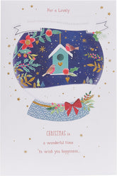UK Greetings Christmas greeting card featuring a snow globe with robins and a granddaughter, with multi-caption festive design.