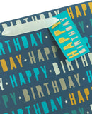 Large blue UK Greetings birthday gift bag with festive "Happy Birthday" design and handles for special gift packaging.