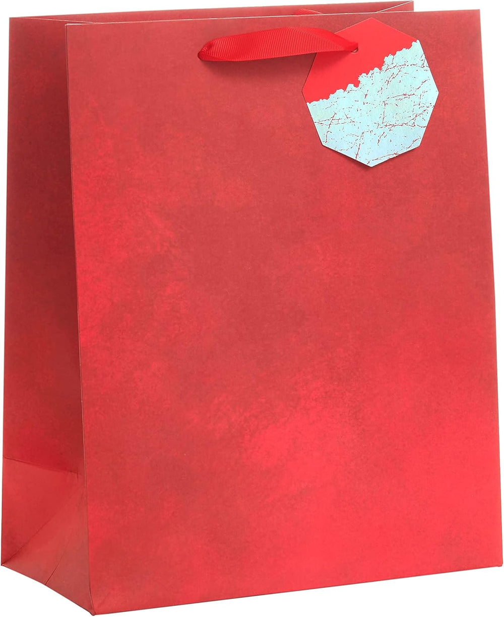 Large red UK Greetings gift bag for him or her, ideal for Christmas, birthdays, or celebrations, with festive design.