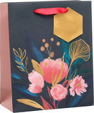 UK Greetings medium floral gift bag for women, featuring a colorful floral design, ideal for special occasions.