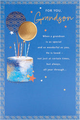 Blue and gold birthday greeting card for grandson by UK Greetings, featuring cake design and celebratory imagery.
