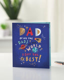 UK Greetings Father's Day card for Dad with a sweet space design, featuring colorful planets and stars on the front.