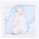 UK Greetings wedding greeting card with 3D cake design, featuring layered cake visuals and elegant wedding motifs.