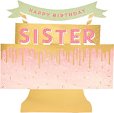 UK Greetings 3D pop-up sister birthday card featuring a colorful cake design, perfect for celebrating with loved ones.