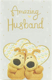UK Greetings Amazing Husband wedding anniversary greeting card featuring cute Boofles illustration with festive design elements.