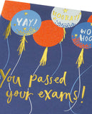 UK Greetings balloons design exams congratulations card featuring colorful balloon illustrations and celebratory message.