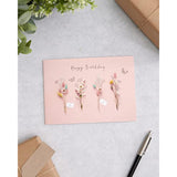 UK Greetings birthday card for her featuring dried flower design, includes envelope, ideal for female friends.