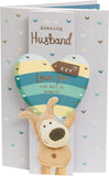 UK Greetings Boofle holding heart above head husband birthday card featuring cute cartoon character and cheerful design.