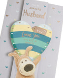 UK Greetings Boofle holding a heart above his head on a birthday card for husband, a cheerful greeting card design.