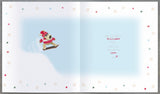 UK Greetings Boofle snowboarding Christmas card featuring Boofle the dog in festive winter attire for sons, perfect for holiday greetings.