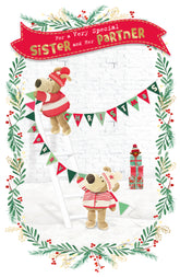 UK Greetings Boofles standing on ladder Christmas card featuring hanging design for sister and partner, festive greeting card.