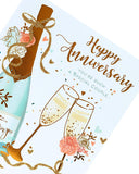UK Greetings wedding anniversary greeting card with champagne gold foil design showing a special couple celebration scene