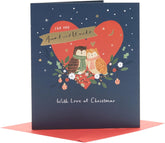 UK Greetings Christmas card featuring festive owl design for Aunt and Uncle, with colorful holiday illustrations and cheerful message.