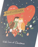 UK Greetings Christmas card for aunt and uncle featuring festive owl design, colorful holiday-themed greeting card.