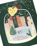 UK Greetings Christmas card for Both of You featuring a festive city ice rink design, cheerful winter scene with holiday decorations.