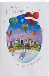 UK Greetings colorful hot air balloon anniversary greeting card for husband, featuring vibrant balloon design and heartfelt message.