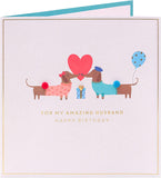 UK Greetings cute sausage dog design husband birthday greeting card with adorable dog illustration on front.
