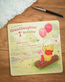Disney's Winnie the Pooh 1st granddaughter birthday card by UK Greetings featuring Pooh with colorful designs and cheerful message.