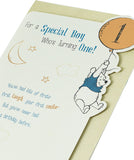 Disney Winnie the Pooh baby boy 1st birthday greeting card by UK Greetings featuring Winnie the Pooh and festive designs.
