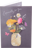 UK Greetings flower in jar design birthday greeting card with colorful floral illustration on a white background.