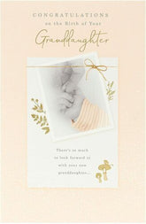 UK Greetings gold foil greeting card celebrating a new granddaughter with congratulatory message and decorative design.