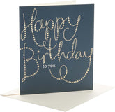 UK Greetings Golden Stars Happy Birthday greeting card featuring gold star accents and cheerful birthday message.