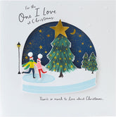 UK Greetings romantic Christmas card featuring ice skaters in a snow globe design, perfect for expressing love during the holidays.