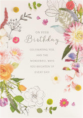 UK Greetings Into the Meadow greeting card featuring a cute floral design with colorful flowers and greenery.