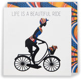 UK Greetings Kindred X Afrotouch greeting card featuring colorful artwork and the message "Life Is a Beautiful Ride."