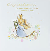 UK Greetings Peter Rabbit new baby congratulations card featuring a colorful illustration of Peter Rabbit and floral accents.