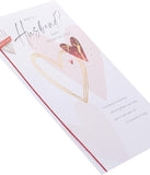 UK Greetings Valentine's Day card for husband featuring a "What Is a Husband?" design, with romantic illustrations on the front.