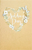 UK Greetings wedding greeting card for him, her, or friend featuring an elegant white flower design.