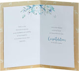 UK Greetings wedding greeting card for him, her, or friend featuring a white flower design and elegant floral artwork.