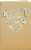 UK Greetings wedding greeting card for him, her, or a friend featuring a white flower design and elegant floral artwork.